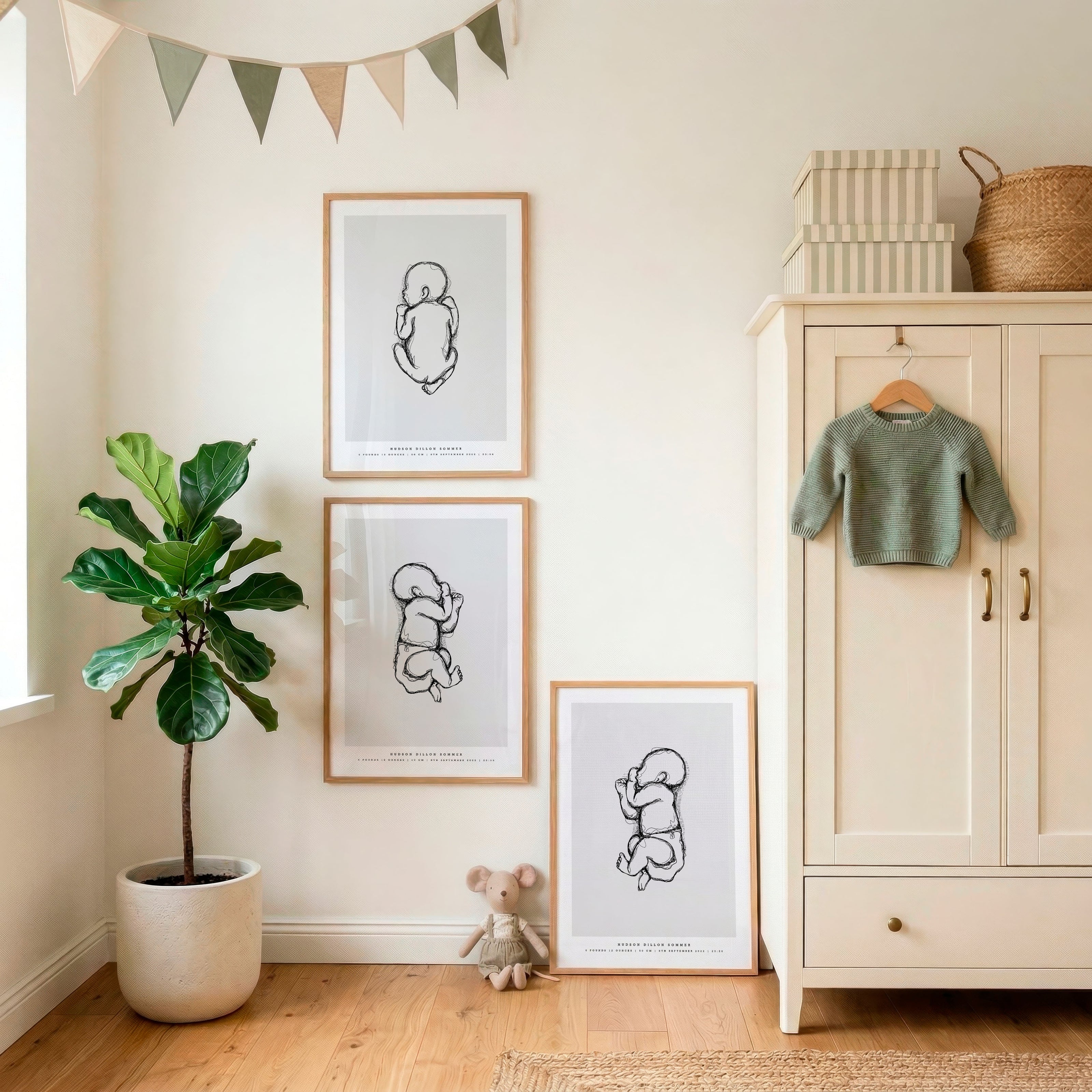 Three personalized birth posters displayed in a nursery, featuring newborn illustrations in actual birth size with names and birth details.